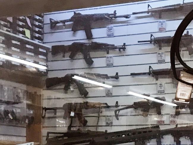 Fully automatic AK47's with M16's, M4's and a massive sniper rifle are in plain view and for sale at Christchurch's largest gun shop. Picture: News Corp Australia