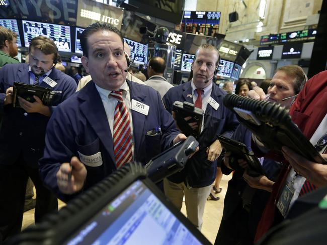 Tommy Kalikas, second left, works with fellow traders on the floor of the New York Stock Exchange, Tuesday, June 30, 2015. U.S. stocks are rising broadly in early trading as investors hope for a last-minute deal on Greece's debt woes. (AP Photo/Richard Drew)