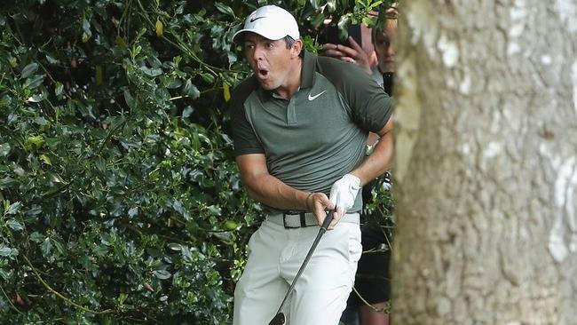 Rory McIlroy reacts to hitting a fan.