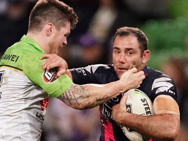 Cameron Smith is tackled by John Bateman on Saturday night.