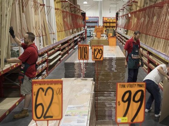 An employee assists a customer shopping for timber at a Bunnings Warehouse store, operated by Wesfarmers Ltd., in Sydney, Australia, on Tuesday, Feb. 16, 2021. The retail conglomerate Wesfarmers is scheduled to release earnings on Feb. 18. Photographer: Brent Lewin/Bloomberg via Getty Images