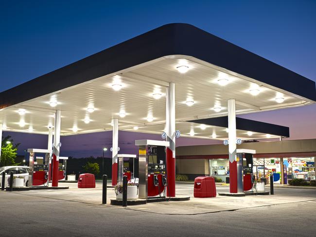 Modern gas station convenience store at early evening.  Plentiful copy space top and bottom.