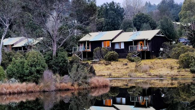 No snow on my visit but beautiful still winter conditions enabling reflections of cabins on the water at Cradle Mountain Lodge, Tasmania. Picture: AMANDA DUCKER