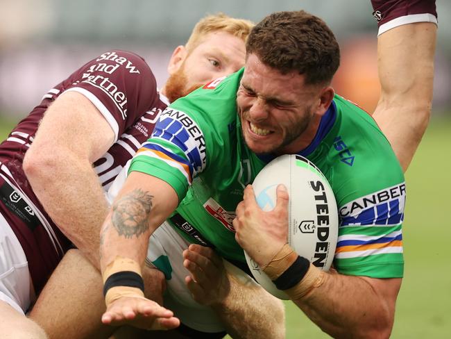 GOSFORD, AUSTRALIA - FEBRUARY 25: Adam Elliott of the Raiders is tackled by Brad Parker of the Sea Eagles during the NRL Trial Match between the Manly Sea Eagles and the Canberra Raiders at Central Coast Stadium on February 25, 2022 in Gosford, Australia. (Photo by Ashley Feder/Getty Images)