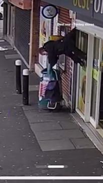 Woman caught upside down on store shutters