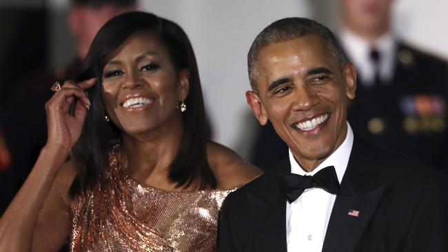 Shiny happy faces ... President Barack Obama and first lady Michelle Obama wait to greet their guests.