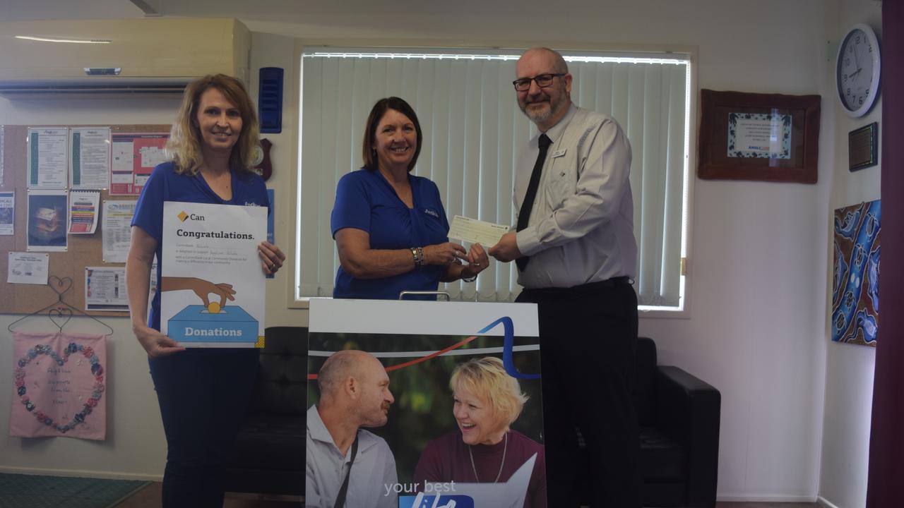 GIVING SEASON:Commonwealth Bank Biloela Manager Jason Spence handing over the donation to Anglicare CQ's Deborah Vonhoff and Lori Simpkins.