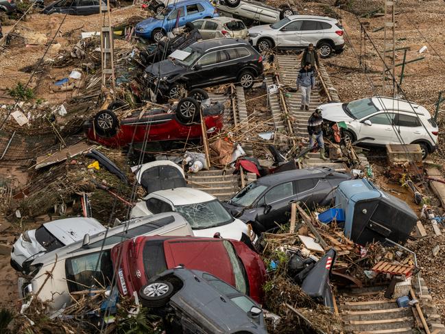 Cars and a campervan are strewn over railway tracks after being swept up in the recent flash flooding in the municipality Alfafar. Picture: Getty