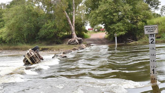 A 47-year-old man is believed to have been taken by a crocodile at Cahills Crossing while walking across with two women. The wreckage of a LandCruiser is from a separate incident. PICTURE: Katrina Bridgeford