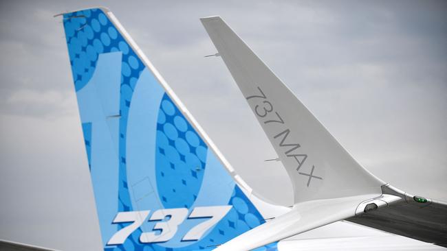 (FILES) This photograph taken on June 18, 2023 shows the Boeing 737 tail fin and a Boeing 737 Max winglet (R) during the International Paris Air Show at the ParisâLe Bourget Airport. Boeing on July 8, 2024 said it had "reached an agreement" with the US Department of Justice over two fatal 737 MAX crashes more than five years ago. "We have reached an agreement in principle on terms of a resolution with the Justice Department, subject to the memorialization and approval of specific terms," Boeing told AFP in a statement. (Photo by JULIEN DE ROSA / AFP)