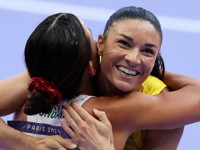 PARIS, FRANCE - AUGUST 08: Michelle Jenneke of Team Australia embraces Greta Kerekes of Team Hungary after competing in the Women's 100m Hurdles Repechage on day thirteen of the Olympic Games Paris 2024 at Stade de France on August 08, 2024 in Paris, France. (Photo by Cameron Spencer/Getty Images)