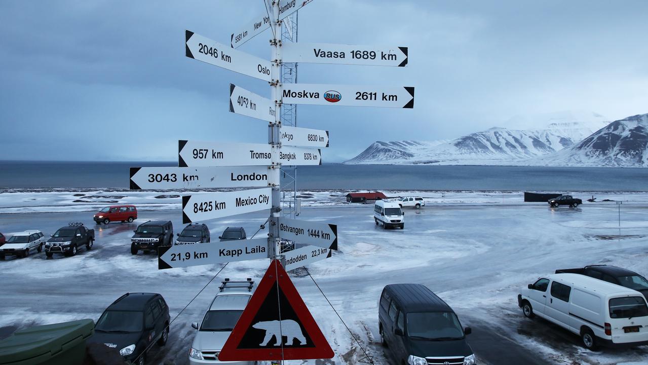Polar bear warning sign and city distances outside Longyearbyen airport. Picture: Ella Pellegrini