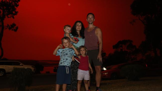 German family Kai and Deniz Kirschbaum with their three children sheltering at the Mallacoota community centre. Picture: David Caird