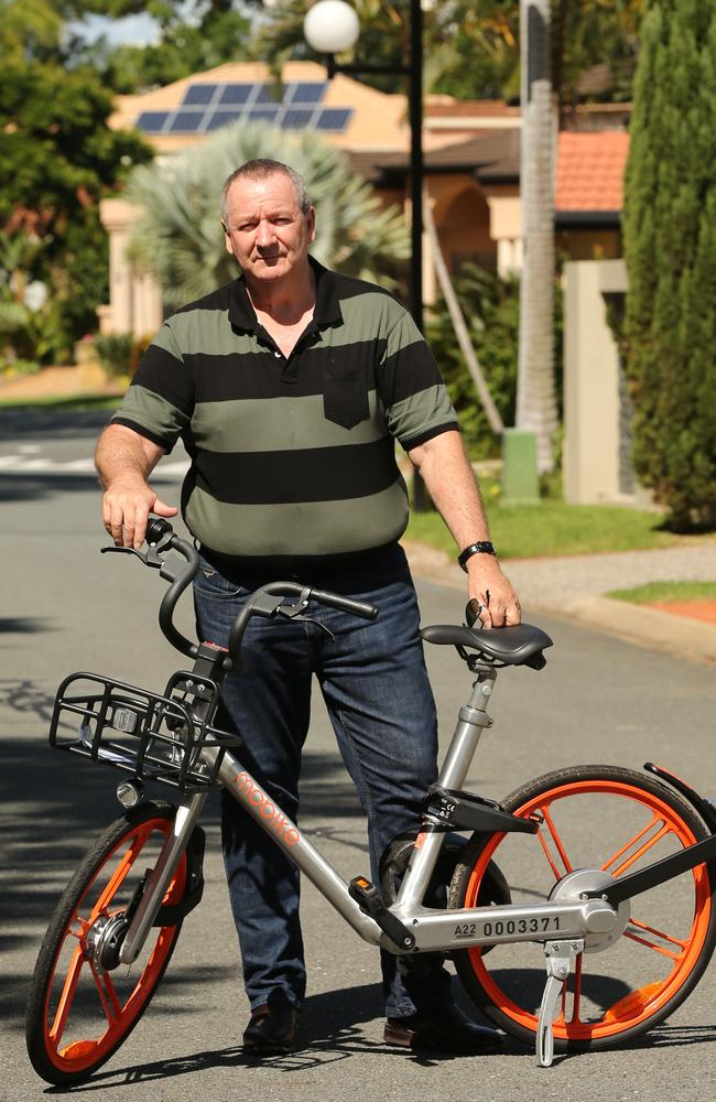 Wayne Richardson of Surfers Paradise Waters pictured with one of the Mobikes that was left in front of his home in Southport. Picture Mike Batterham