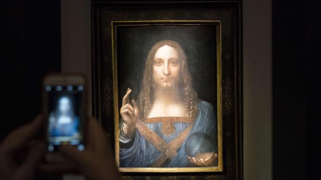 NEW YORK, NY - NOVEMBER 15: A visitor takes a photo of the painting 'Salvator Mundi' by Leonardo da Vinci at Christie's New York Auction House, November 15, 2017 in New York City. The coveted painting is set to be auctioned off on Wednesday night and has been guaranteed to sell for over $100 million.(Drew Angerer/Getty Images) == FOR NEWSPAPERS, INTERNET, TELCOS & TELEVISION USE ONLY ==