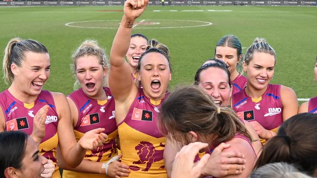 Lions players celebrate their win over the Kangaroos at full time. (Photo by Steve Bell/Getty Images)