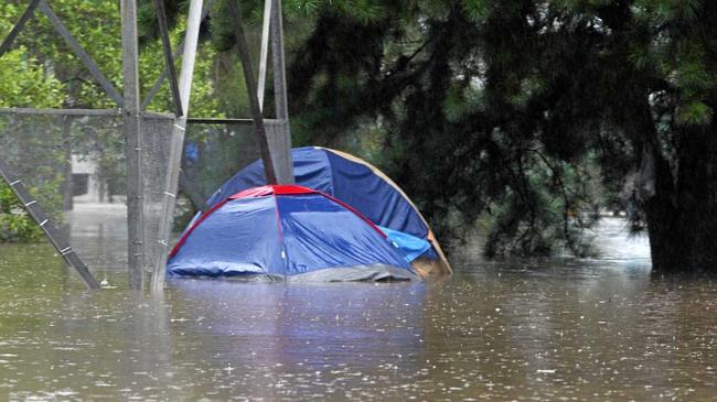 There are no photos of Damian Bathersby's new tent in the Gympie storm so here's a file photo of someone else's predicament after a different storm, somewhere else. Picture: John Gass /TWE250112wet