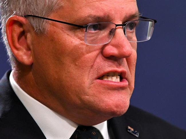 Australia's Prime Minister Scott Morrison speaks to the media to announce sanctions on top Russian officials following the invasion of eastern Ukraine, during a press conference in Sydney on February 23, 2022. (Photo by Steven SAPHORE / AFP)