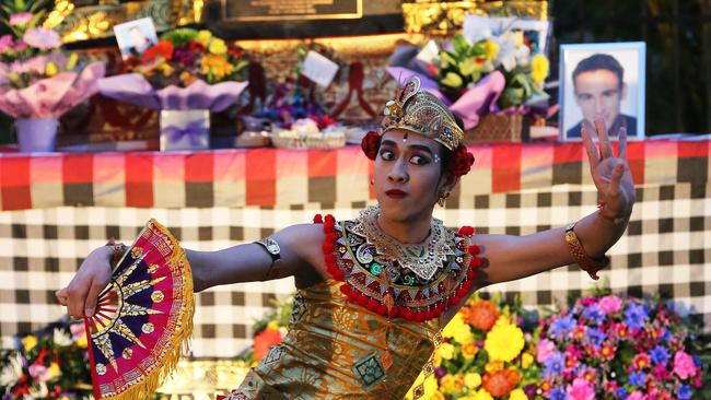 A Balinese dancer performs at the ceremony. Pictured in the background is Billy Hardy, who was killed in the bombings. Picture: Glenn Hampson