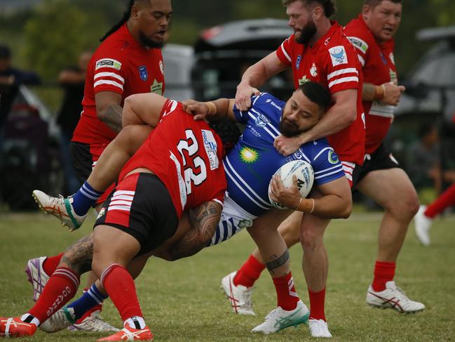 Narellan’s Kenny Niko is wrapped up by the Goannas’ defence. Picture: Warren Gannon Photography