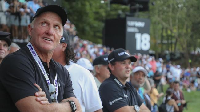 Greg Norman waiting on the 18th green before the start of an LIV playoff.