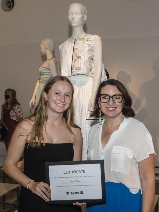 Lucy Forrest (on left) posing in front of her major work.