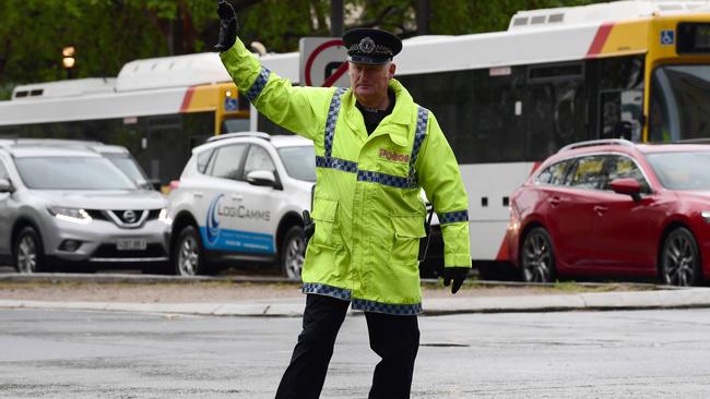 Traffic police officer Sen Const Brian Stratheran handles the cars on North Tce yesterday. Picture: Campbell Brodie.