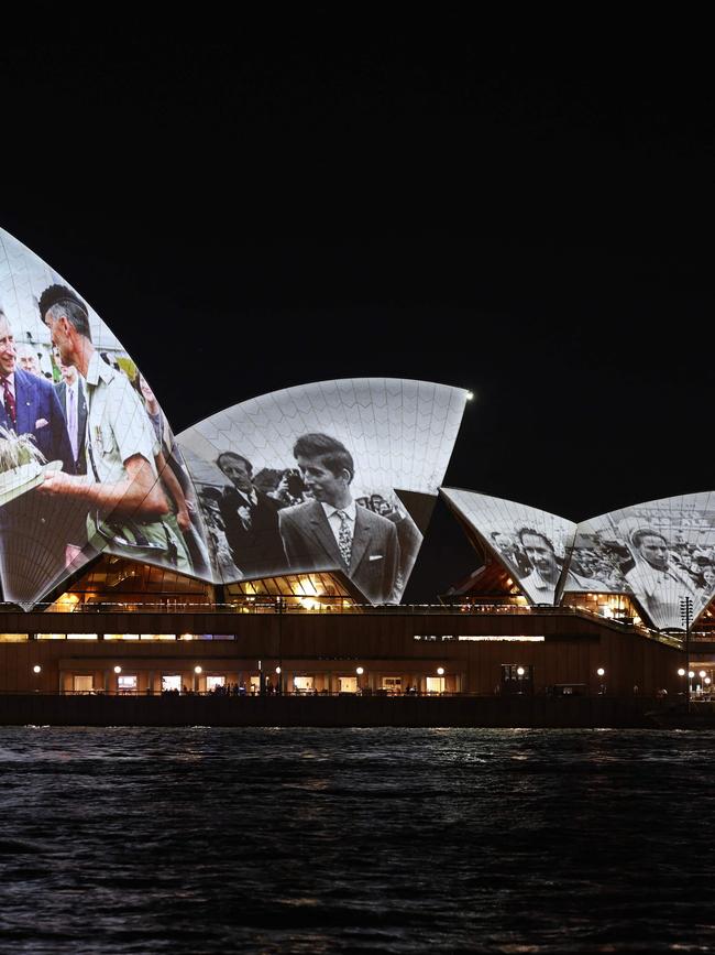 Black and white images of a young King Charles were displayed on the Opera House. (Photo by David GRAY / AFP)