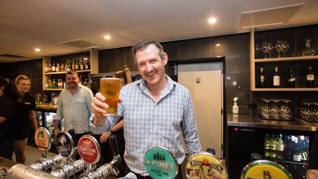 Chief Minister Michael Gunner. pours a beer at the Cavenagh Hotel to mark the reopening of pubs, cafes, and restaurants in the NT on May 15. The Territory Government has announced a tourism and hospitality stimulus voucher scheme to get residents to explore their backyards. Picture: Glenn Campbell