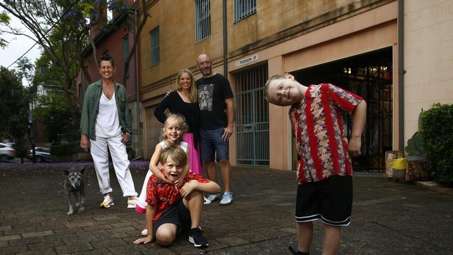 L to R: Michele Morrin with her dog "Fez" and neighbours Lizze- Lamb -3, Rufus Lamb- 8, Emily Lamb, Mike Lamb and Jack Lamb -6 in Thomson street, Darlinghurst. Michele Morrin's photo project to taking photos of all the residents of Thomson street Darlinghurst, was the catalyst that brought the whole community together and lifted everyone's spirits during Covid Lockdown. Picture: John Appleyard