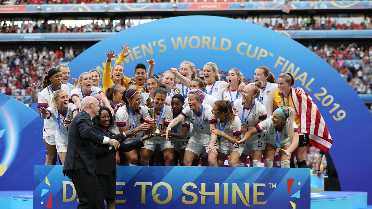 LYON, FRANCE - JULY 07: FIFA Secretary General, Fatma Samoura, and FIFA President, Gianni Infantino present the USA team with the FIFA Women's World Cup Trophy following their victory in the 2019 FIFA Women's World Cup France Final match between The United States of America and The Netherlands at Stade de Lyon on July 07, 2019 in Lyon, France. (Photo by Elsa/Getty Images)