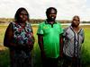 Mirarr traditional owners Yvonne Margarula and Nida Mangarnbarr hold up the judgment documents with a next generation traditional owner Simon Mudjandi following Friday's Jabiru Township Native Title determination in Jabiru, NT.
Picture: Justin Kennedy