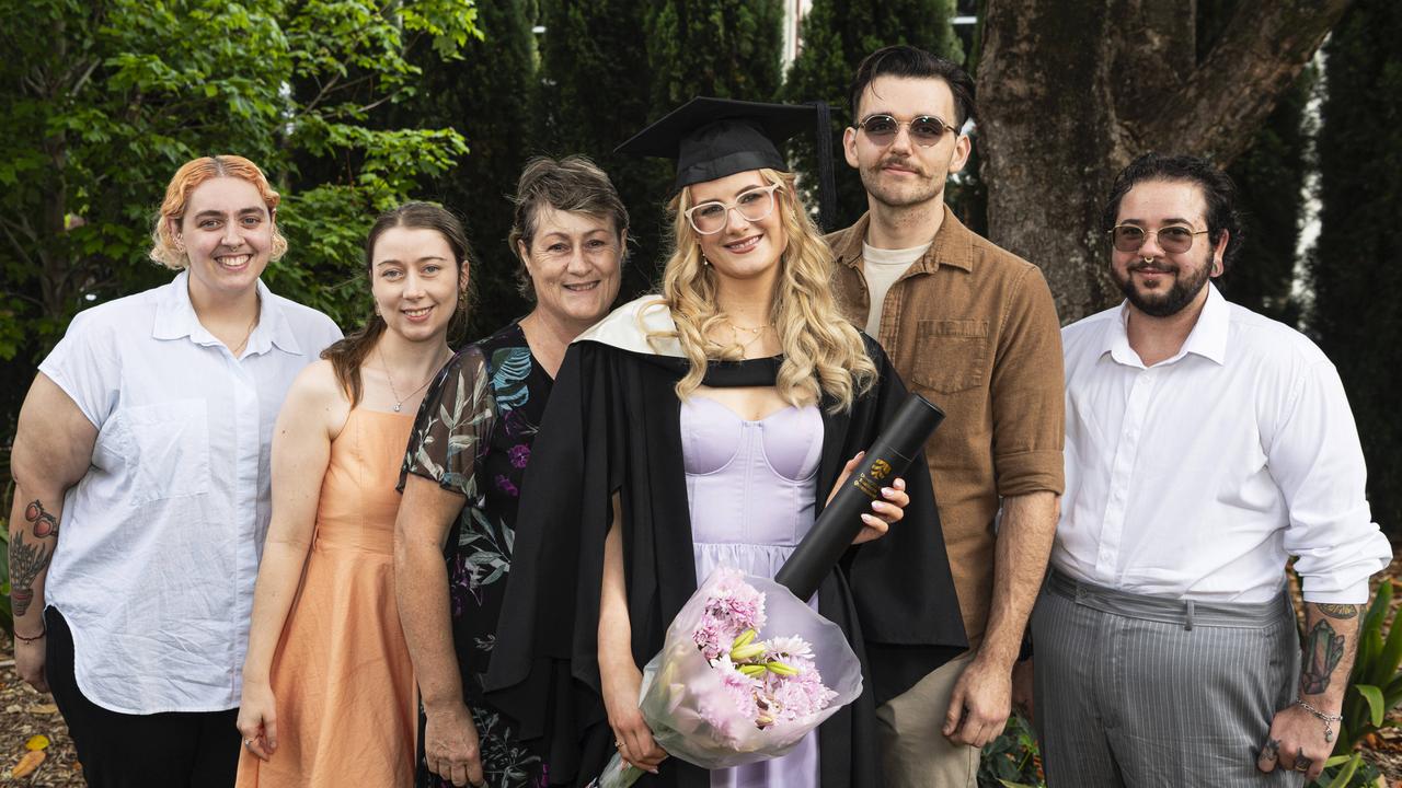 Double degree graduate Emily Kelleher (Bachelor of Arts and Bachelor of Laws) with family and friends (from left) Rhiannon Howard, Mandy Gabler, Donna Kelleher, Malcolm Kelly and Sigh Howard at a UniSQ graduation ceremony at The Empire, Wednesday, October 30, 2024. Picture: Kevin Farmer