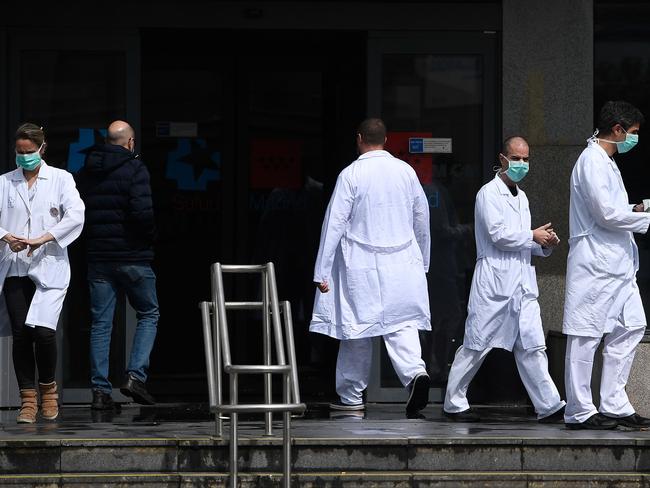 Health workers stand outside La Paz hospital in Madrid. Picture: AFP