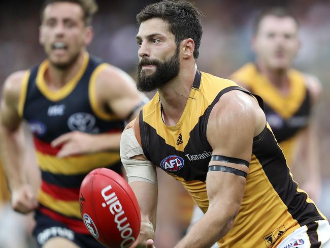 David Mirra getting away a handball for Hawthorn against Adelaide this year.