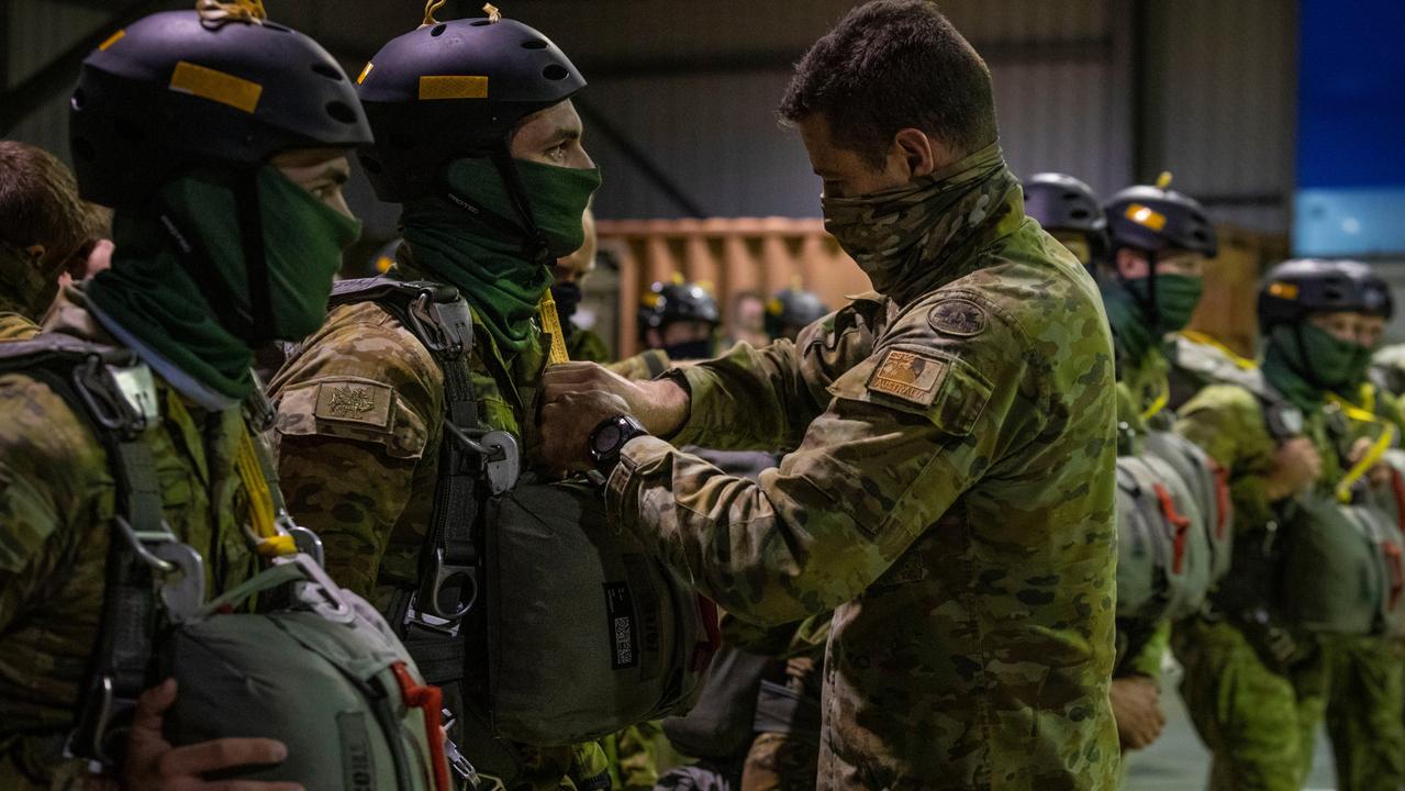 Australian Army special forces soldiers wait for equipment to be checked by instructors during the military static-line operator course at the Australian Defence Force Parachuting School at HMAS Albatross, Nowra, NSW. Picture: Sgt Sebastian Beurich