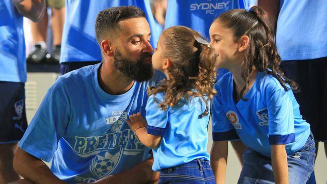 Alex Brosque of Sydney FC kisses his daughter after the Sydney FC v Newcastle Jets A league match at Allianz Stadium. pic Mark Evans