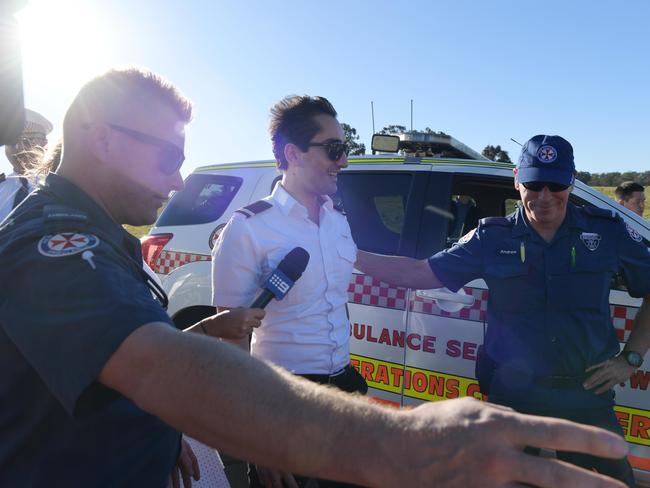 The pilot (pictured centre) and his passenger where lucky to escape with minor injuries. Picture: Simon Bullard/AAP