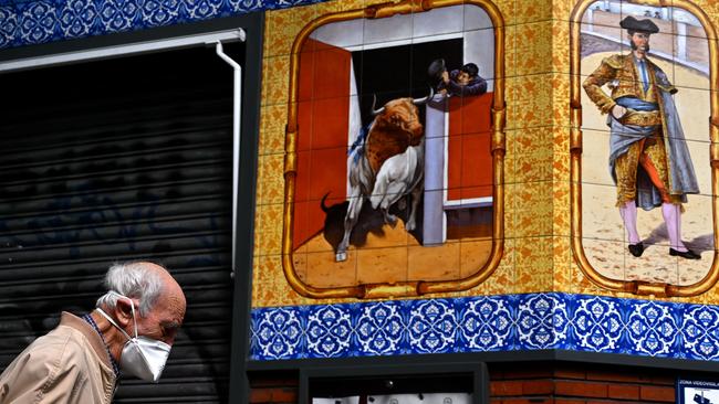 An elderly man walks past a closed restaurant in Madrid on Saturday. Picture: AFP