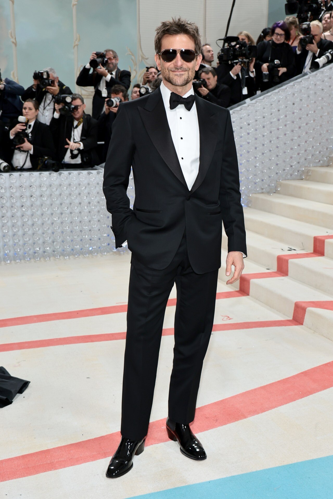 <p>At the 2023 Met Gala, Cooper went classic, making a reference to Karl Lagerfeld with his own iconic aviator sunglasses.&nbsp;</p>