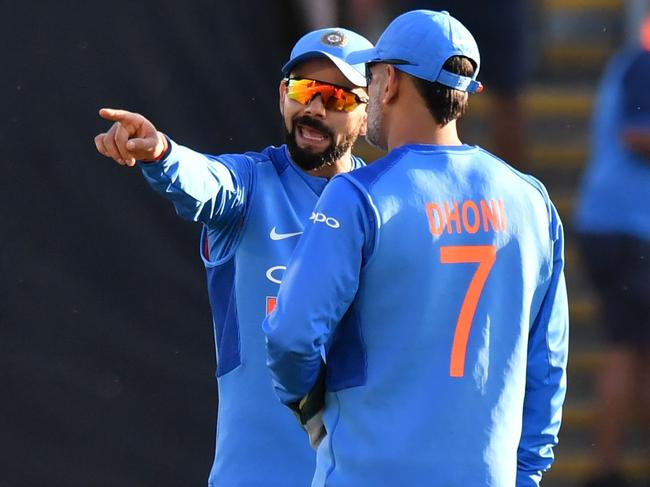 MS Dhoni (R) and Virat Kohli discuss field placings during a T20I. Picture: Anthony Devlin