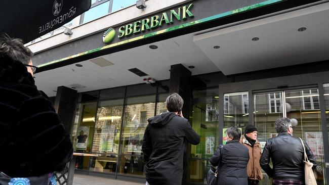 Citizens wait in front of the entrance of a branch of the Russian Sbertbank in the centre of Zagreb on February 28, 2022. Citizens rushed to the bank in an attempt to retrieve their money following the Russian attack on Ukraine. Picture: Denis Lovrovic / AFP