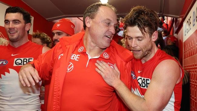 SYDNEY, AUSTRALIA – JULY 13: Swans head coach John Longmire celebrates with Dane Rampe of the Swans after victory during the round 18 AFL match between Sydney Swans and Western Bulldogs at Sydney Cricket Ground, on July 13, 2023, in Sydney, Australia. (Photo by Mark Metcalfe/AFL Photos/via Getty Images)