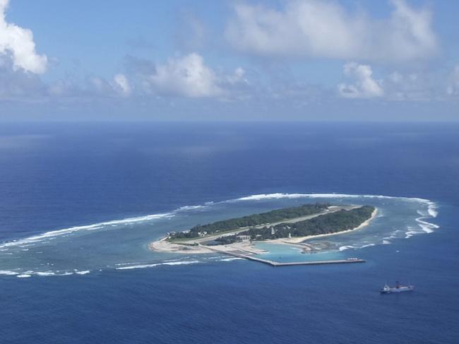An aerial view shows a vessel preparing for a search-and-rescue exercise off Taiping island, in the South China Sea , Tuesday, Nov. 29, 2016, as part of efforts to cement its claim to a key island in the strategically vital waterbody. Eight vessels and three aircraft took part in Tuesday's drill, which simulated a fire aboard a cargo ship that forced crew members to seek safety on Taiping in the Spratly island group. (AP Photo/Johnson Lai)