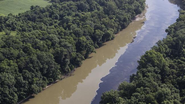 Bourbon mixes with water in the Kentucky River, Wednesday, July 3, 2019, following an overnight fire at a Jim Beam distillery in Woodford County, Ky. Firefighters from four counties responded to the blaze that erupted late Tuesday. (Pat McDonogh/Courier Journal via AP)