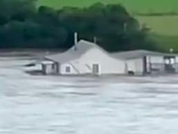 The couple's house was filmed floating away. Picture: Twitter