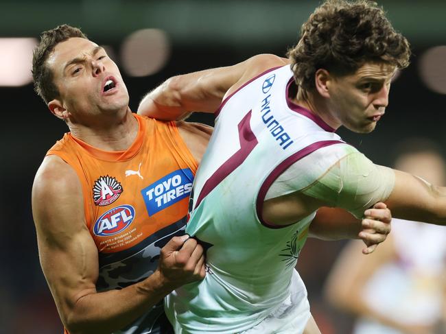 CANBERRA, AUSTRALIA - APRIL 25: Jarrod Berry of the Lions is tackled by Josh Kelly of the Giants during the round seven AFL match between Greater Western Sydney Giants and Brisbane Lions at Manuka Oval, on April 25, 2024, in Canberra, Australia. (Photo by Mark Metcalfe/AFL Photos/via Getty Images )