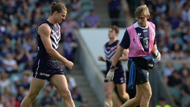 SPORT - AFL, Fremantle Dockers vs Carlton Blues, Subiaco Oval, Perth. Photo by Daniel Wilkins. PICTURED- Fremantle's Nathan Fyfe leaves the field with a trainer, early in the third quarter