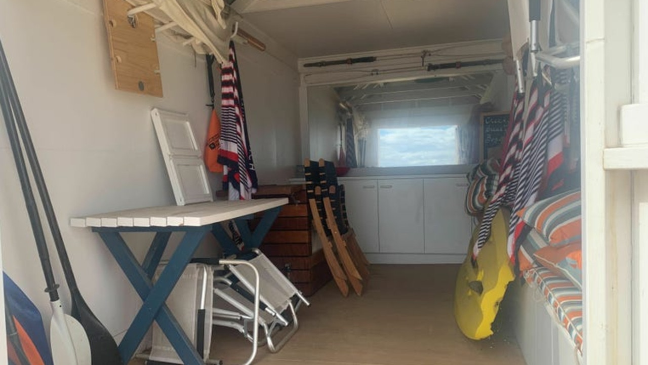 Inside the beach box, featuring cupboards and a small table.