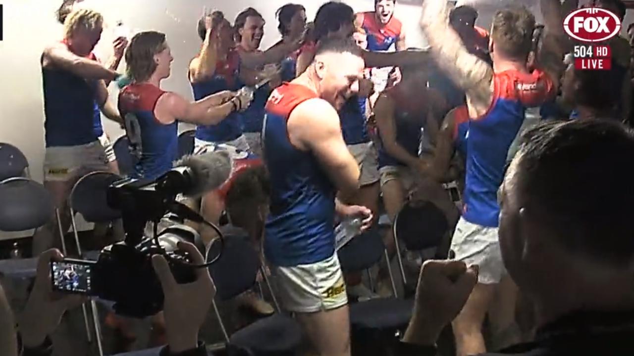 The celebrations inside the Melbourne dressing rooms.